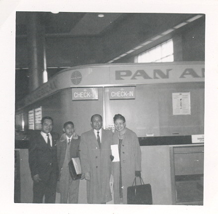 1950s A family posing at a Pan Am ticket counter.